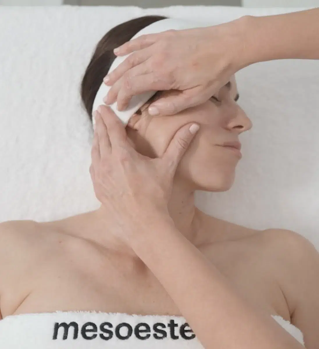 Козметолог почиства лицето с тампон - процедура на mesoestetic